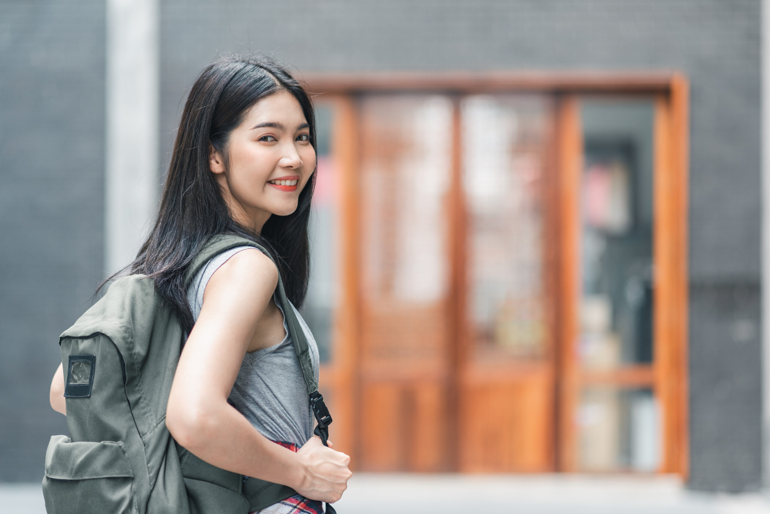 Traveler Asian woman traveling and walking in Beijing, China, ba