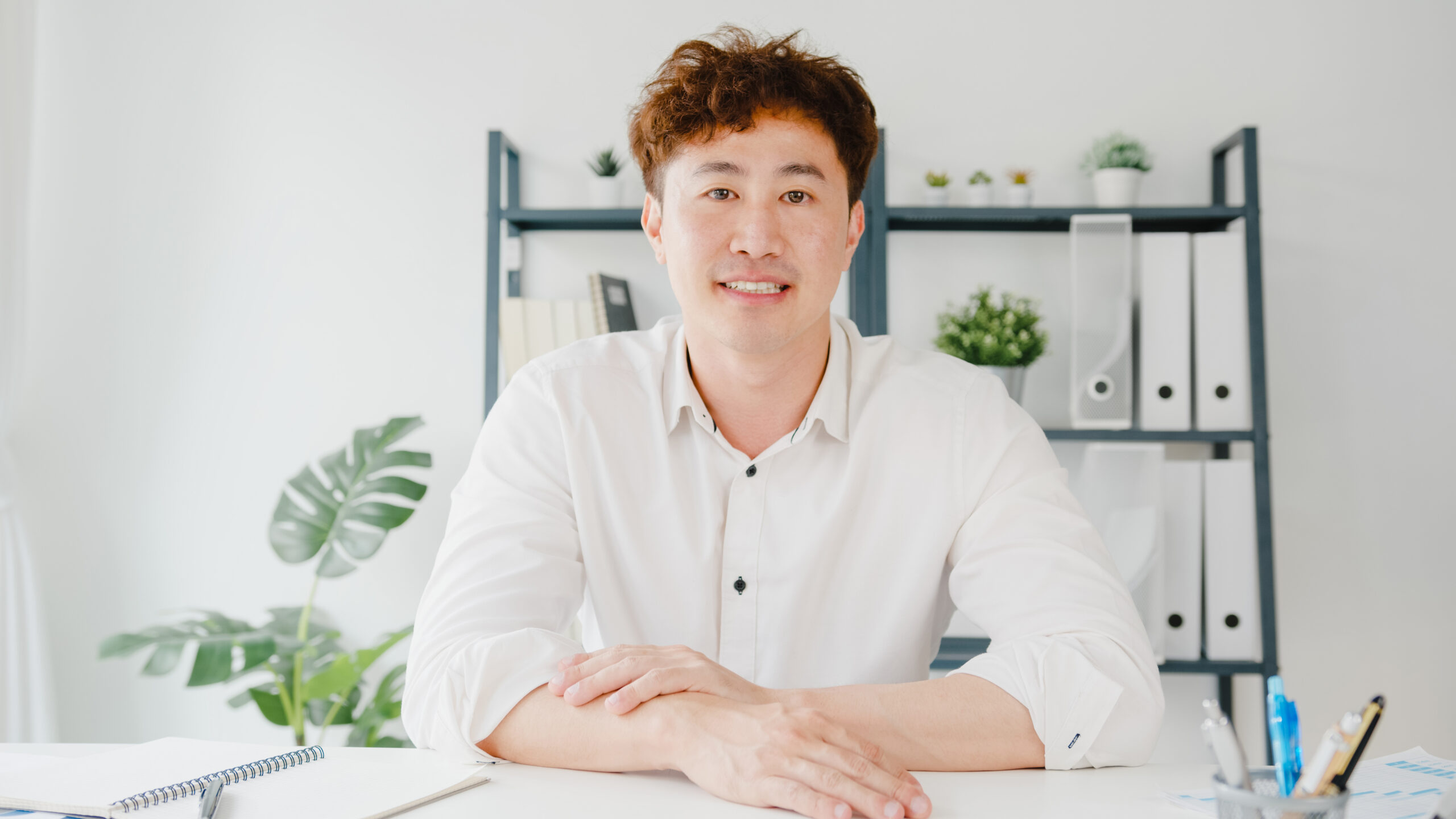 Young Asia businessman using computer laptop talk to colleagues